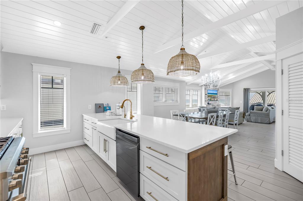316 Beach Road Sarasota, FL 34242 - Photo 79 of 98 a large white kitchen with a large island oven a stove and a chandelier