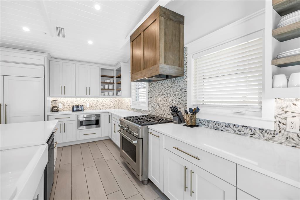 316 Beach Road Sarasota, FL 34242 - Photo 81 of 98 a kitchen with a stove a sink and a refrigerator