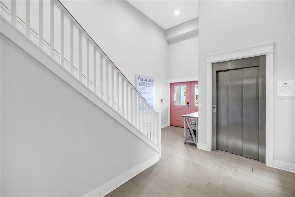 316 Beach Road Sarasota, FL 34242 - Photo 9 of 98 a view of a hallway with white walls and stairs
