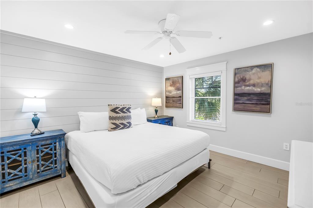 316 Beach Road Sarasota, FL 34242 - Photo 10 of 98 a bedroom with a large bed and a chandelier