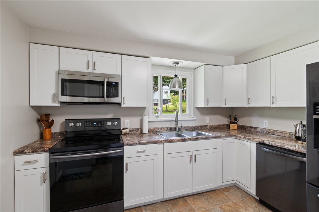 218 Kusak Road Henrietta, NY 14467 - Photo 31 of 33 Kitchen with view to backyard.