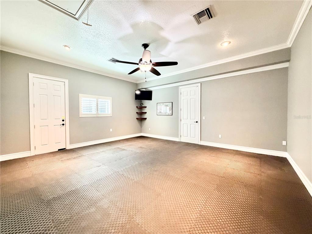 5243 West Lake Butler Road Windermere, FL 34786 - Photo 22 of 43 an empty room with ceiling fan and windows