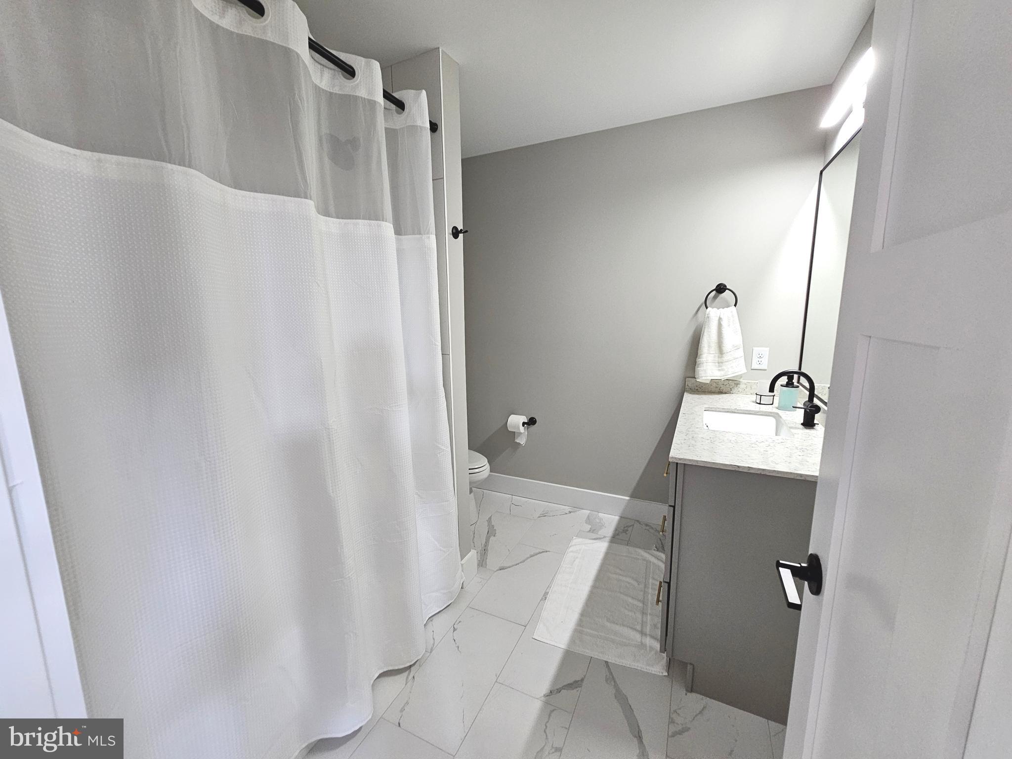 5 Warren Road Lewes, DE 19958 - Photo 26 of 76 a bathroom with a sink and mirror