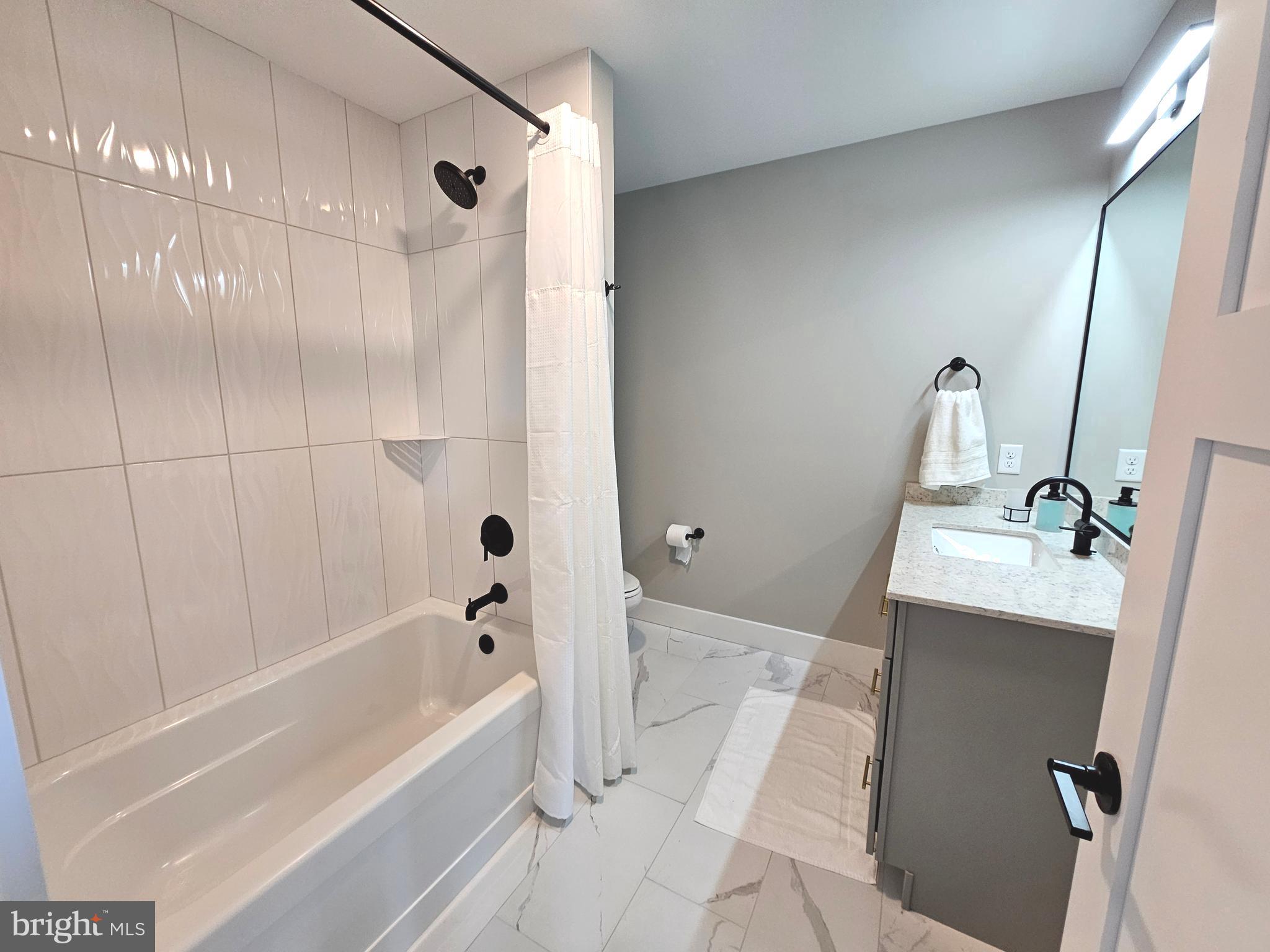 5 Warren Road Lewes, DE 19958 - Photo 27 of 76 a bathroom with a bathtub and shower