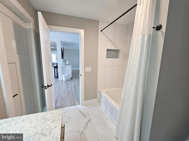 a view of a living room and kitchen with furniture wooden floor and window