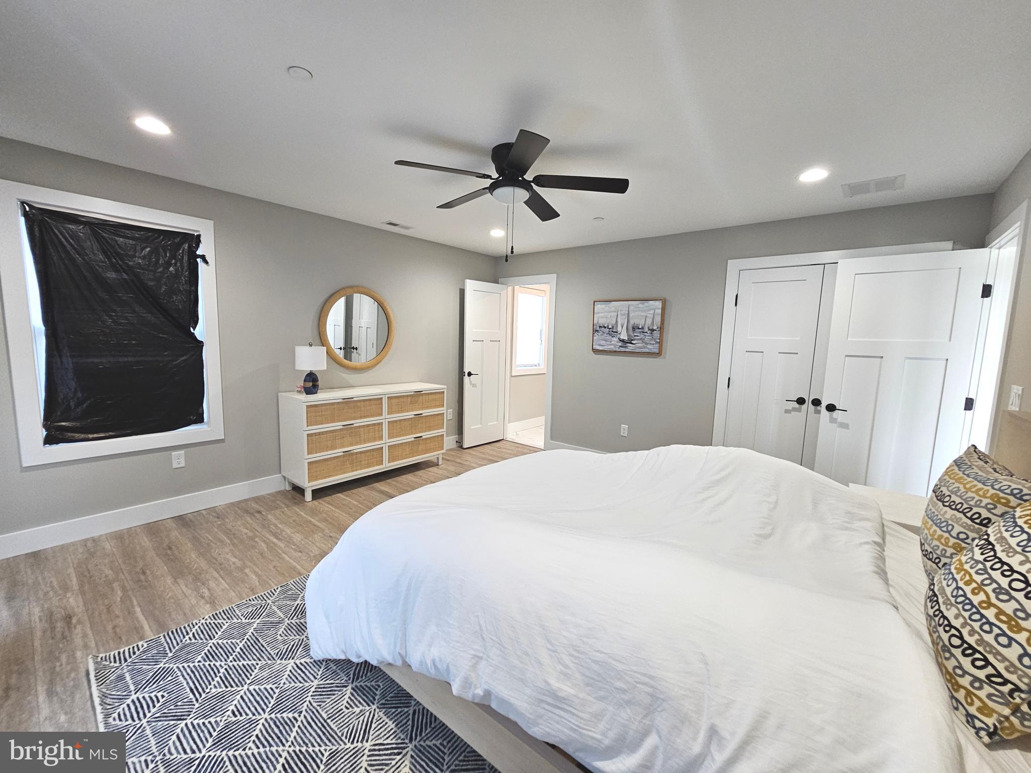 5 Warren Road Lewes, DE 19958 - Photo 31 of 76 a bedroom with a bed and a painting on the wall