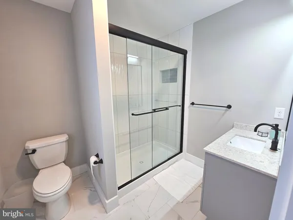 a kitchen with a stove a refrigerator a sink dishwasher with a dining table and chairs