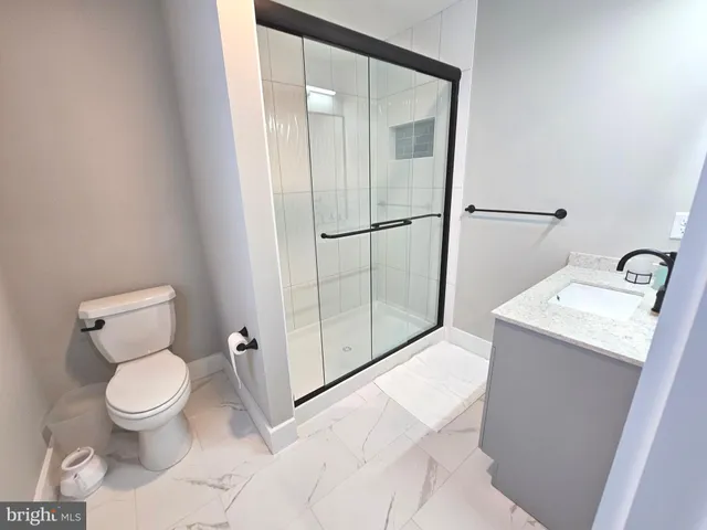 a large kitchen with lots of counter space a sink appliances and living room view