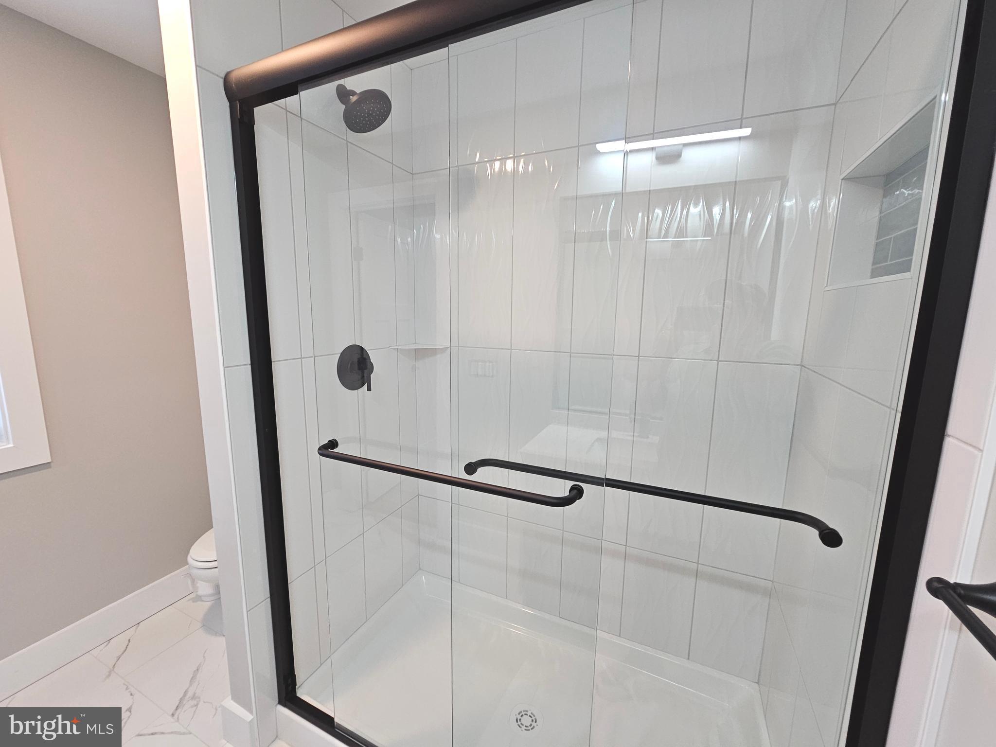 5 Warren Road Lewes, DE 19958 - Photo 34 of 76 a bathroom with a glass shower door