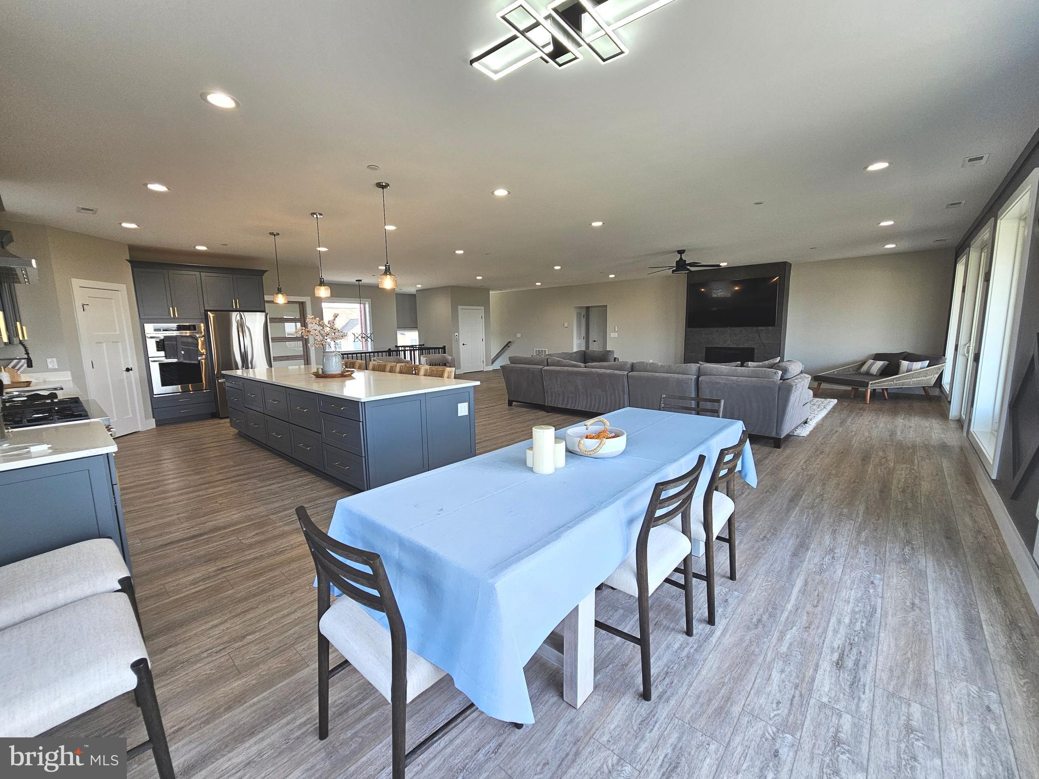 5 Warren Road Lewes, DE 19958 - Photo 48 of 76 a dining room with stainless steel appliances kitchen island granite countertop furniture wooden floor and a view of kitchen