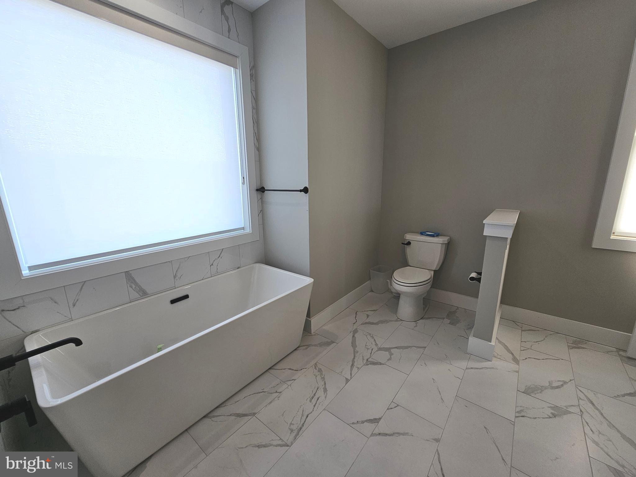 5 Warren Road Lewes, DE 19958 - Photo 53 of 76 a bathroom with a toilet and a bathtub