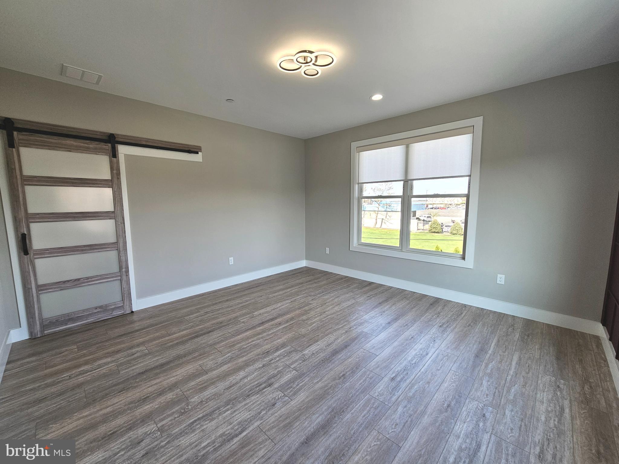5 Warren Road Lewes, DE 19958 - Photo 56 of 76 an empty room with wooden floor and windows