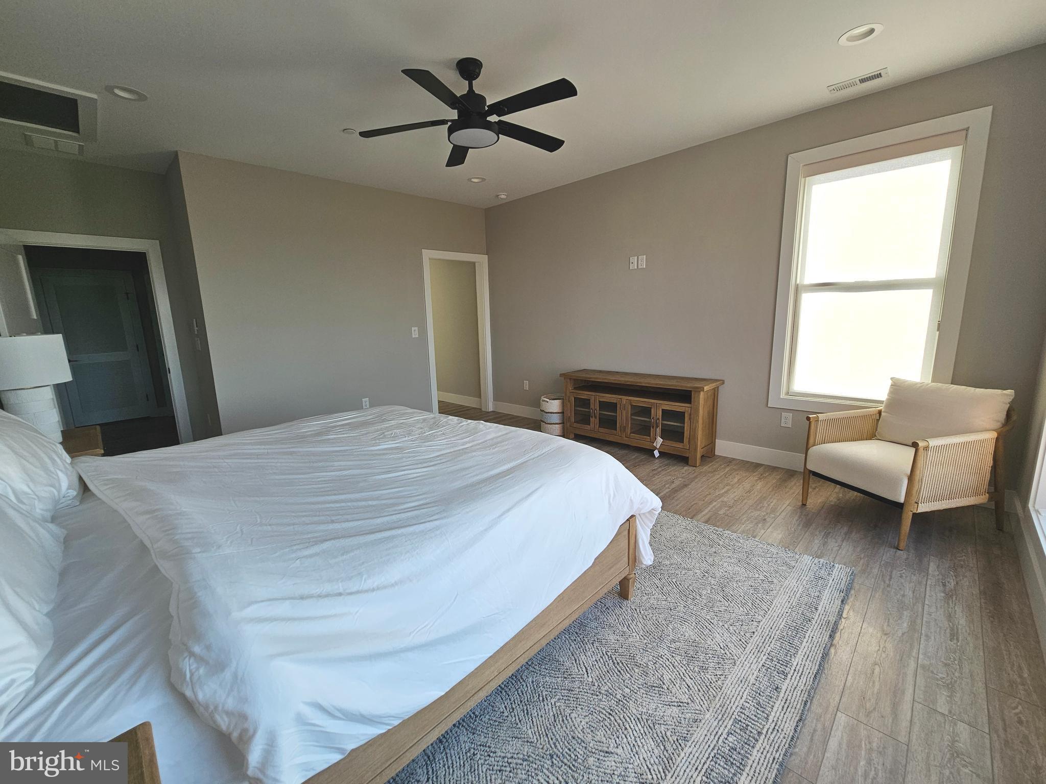 5 Warren Road Lewes, DE 19958 - Photo 62 of 76 a spacious bedroom with a bed a couch and a window