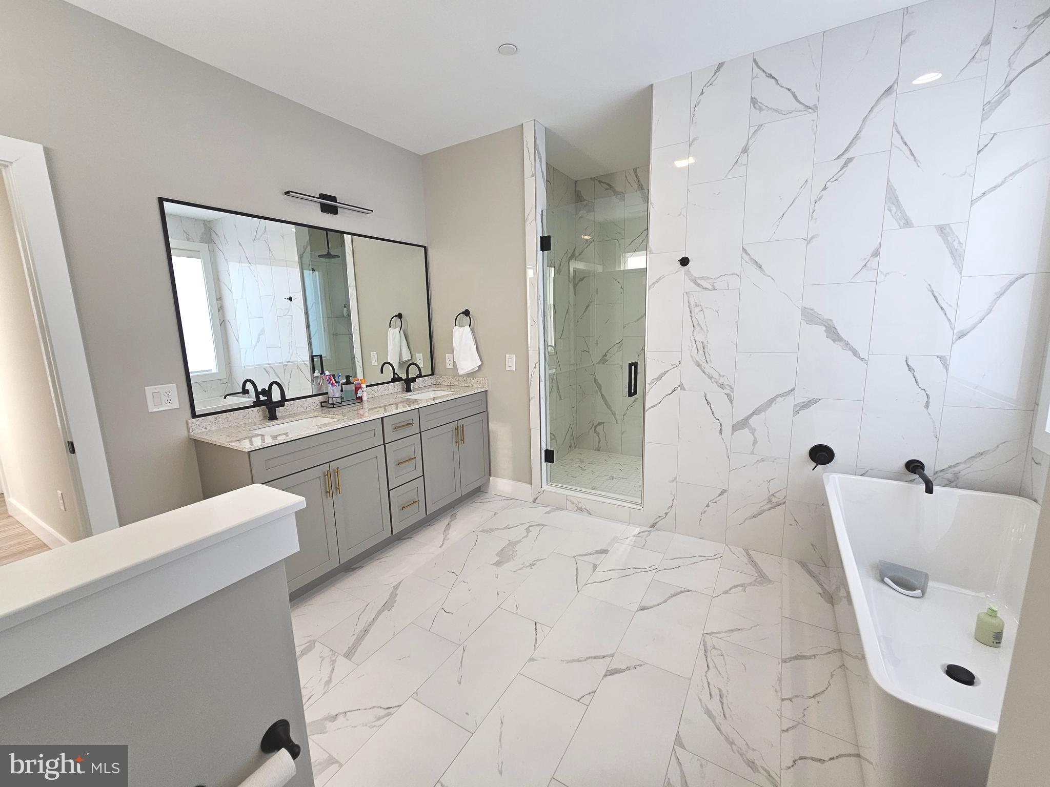 5 Warren Road Lewes, DE 19958 - Photo 65 of 76 a bathroom with a double vanity sink mirror and shower