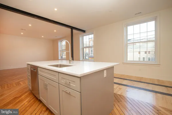 a bathroom with a sink a vanity and a large mirror