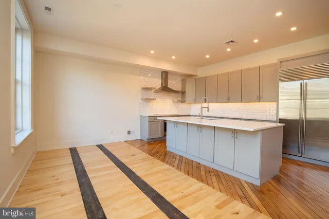 a kitchen with granite countertop a sink and cabinets