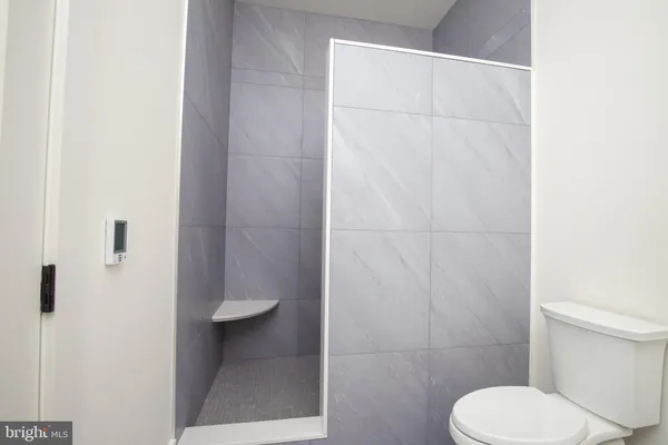 a bathroom with a toilet and a shower