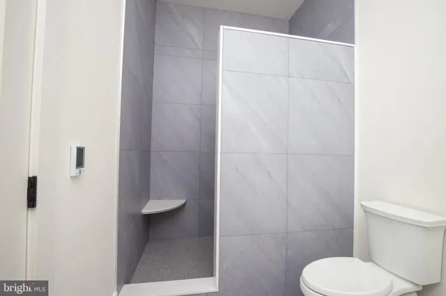 a bathroom with a toilet and a shower