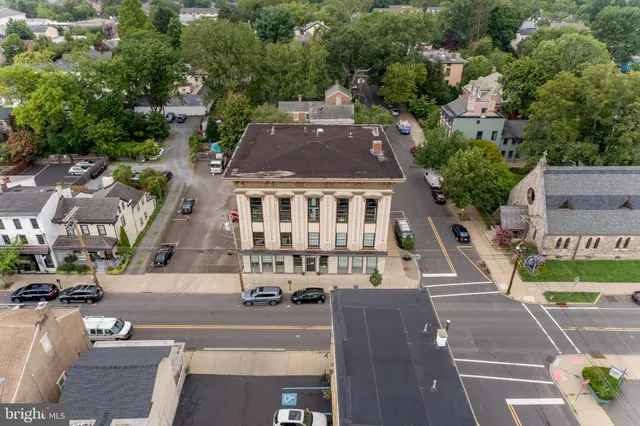 an aerial view of multiple houses with a yard