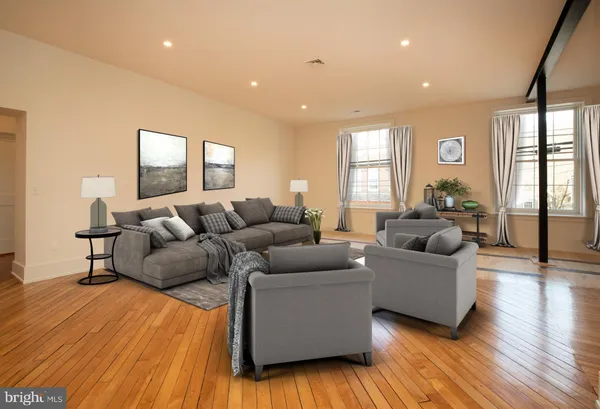 a living room with furniture and wooden floor