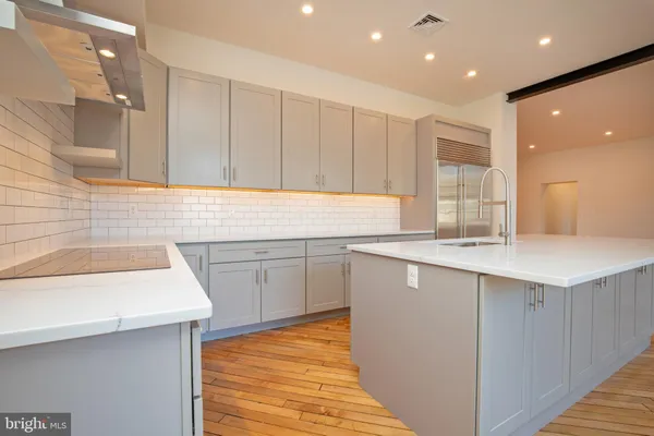 a kitchen with a sink window and cabinets
