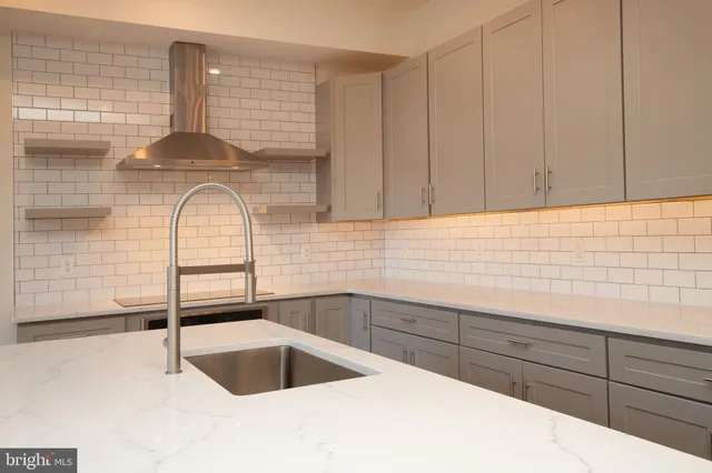 a kitchen with a sink cabinets and chandelier