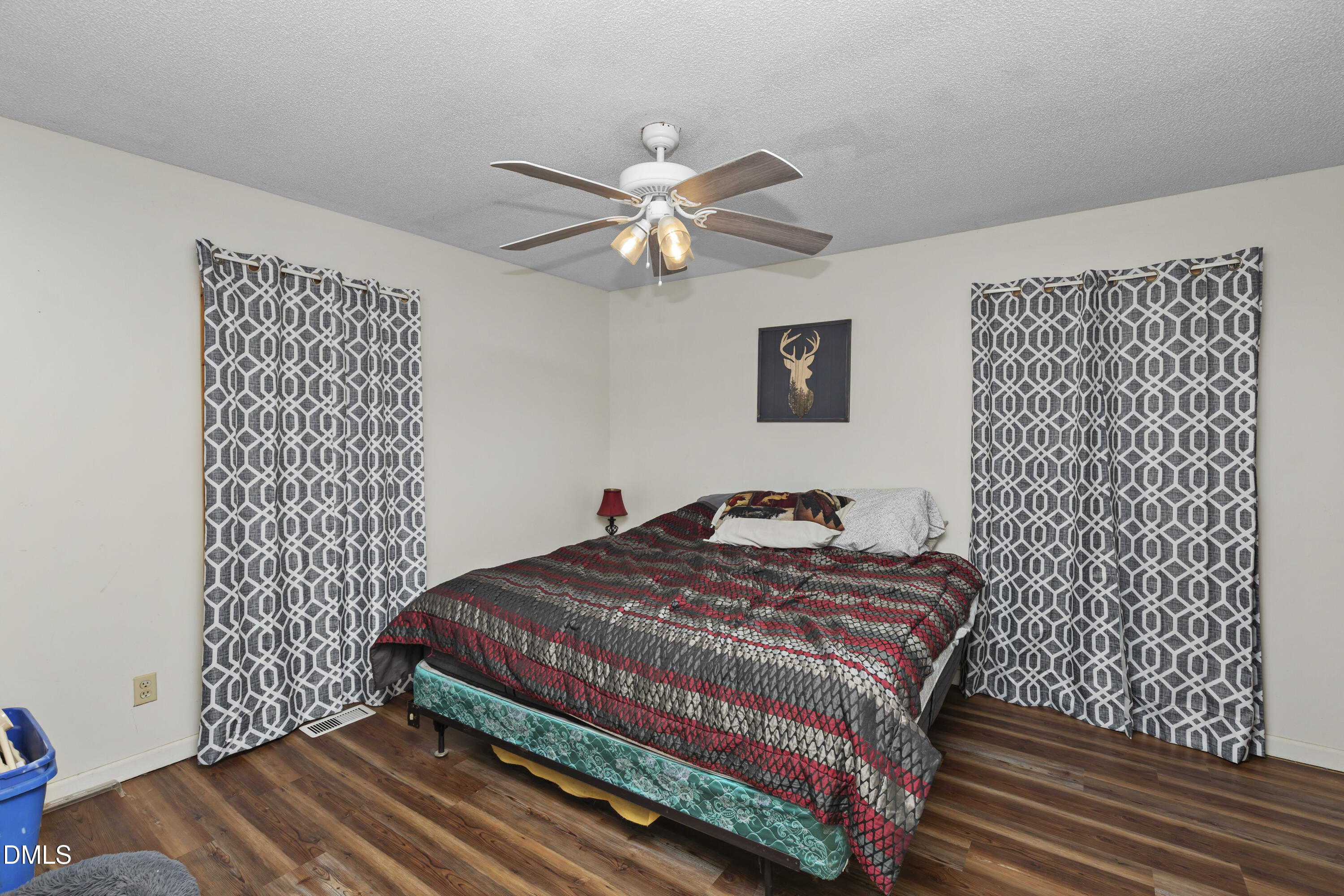 288 Baileys Crossroads Road Benson, NC 27504 - Photo 11 of 26 a bedroom with a bed and a lamp on dresser