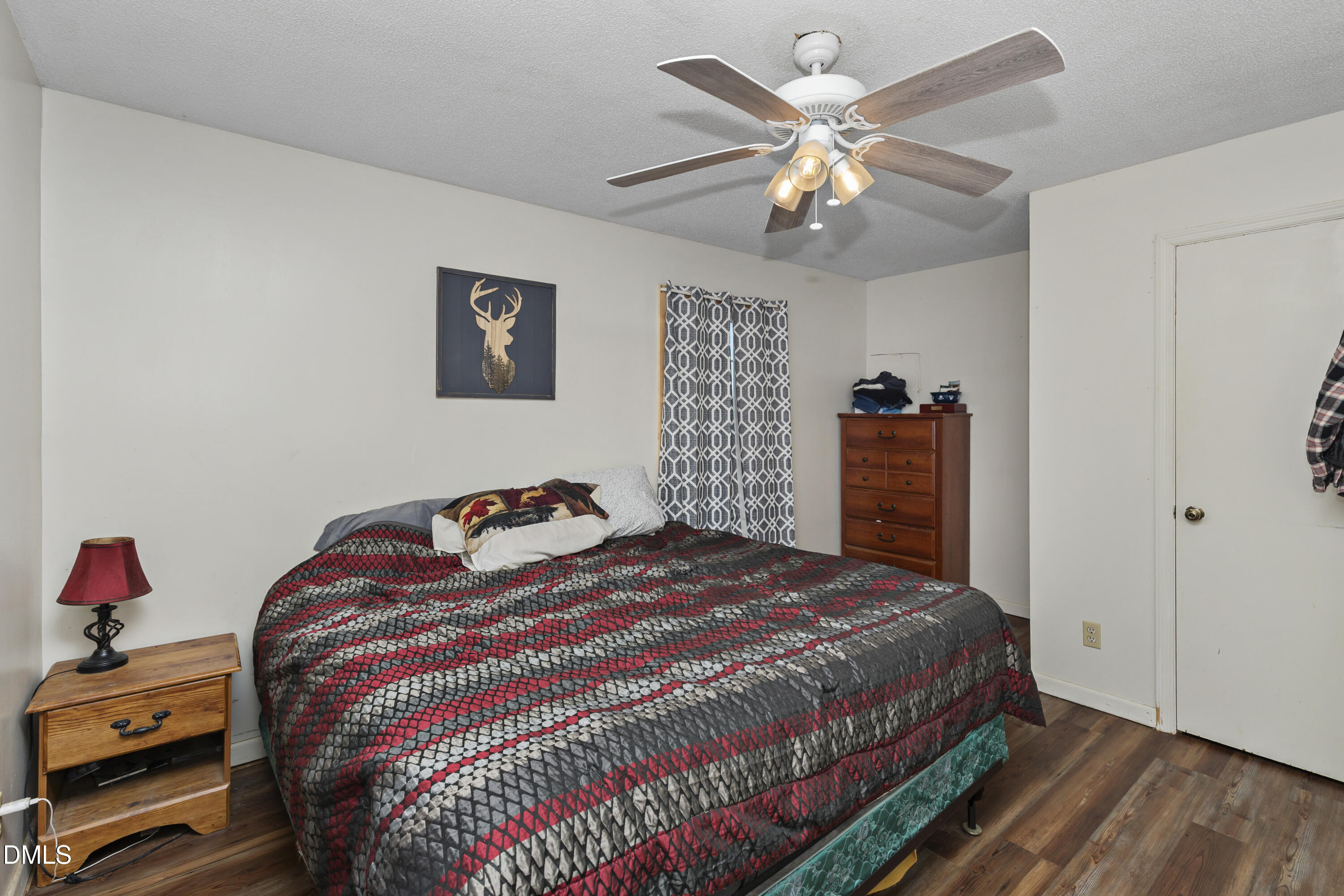 288 Baileys Crossroads Road Benson, NC 27504 - Photo 12 of 26 a bedroom with a bed and a chandelier