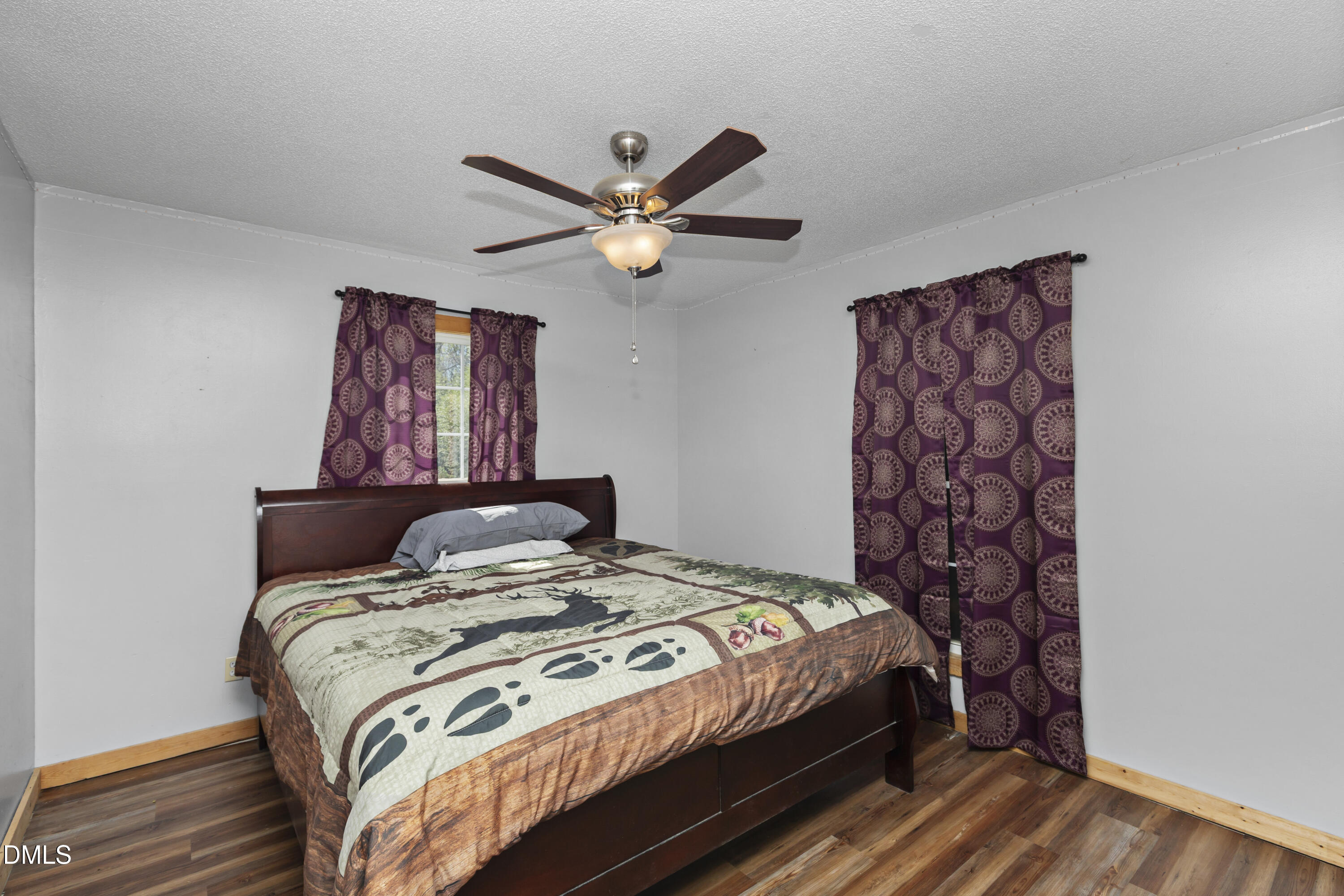 288 Baileys Crossroads Road Benson, NC 27504 - Photo 13 of 26 a bedroom with a bed and a chandelier