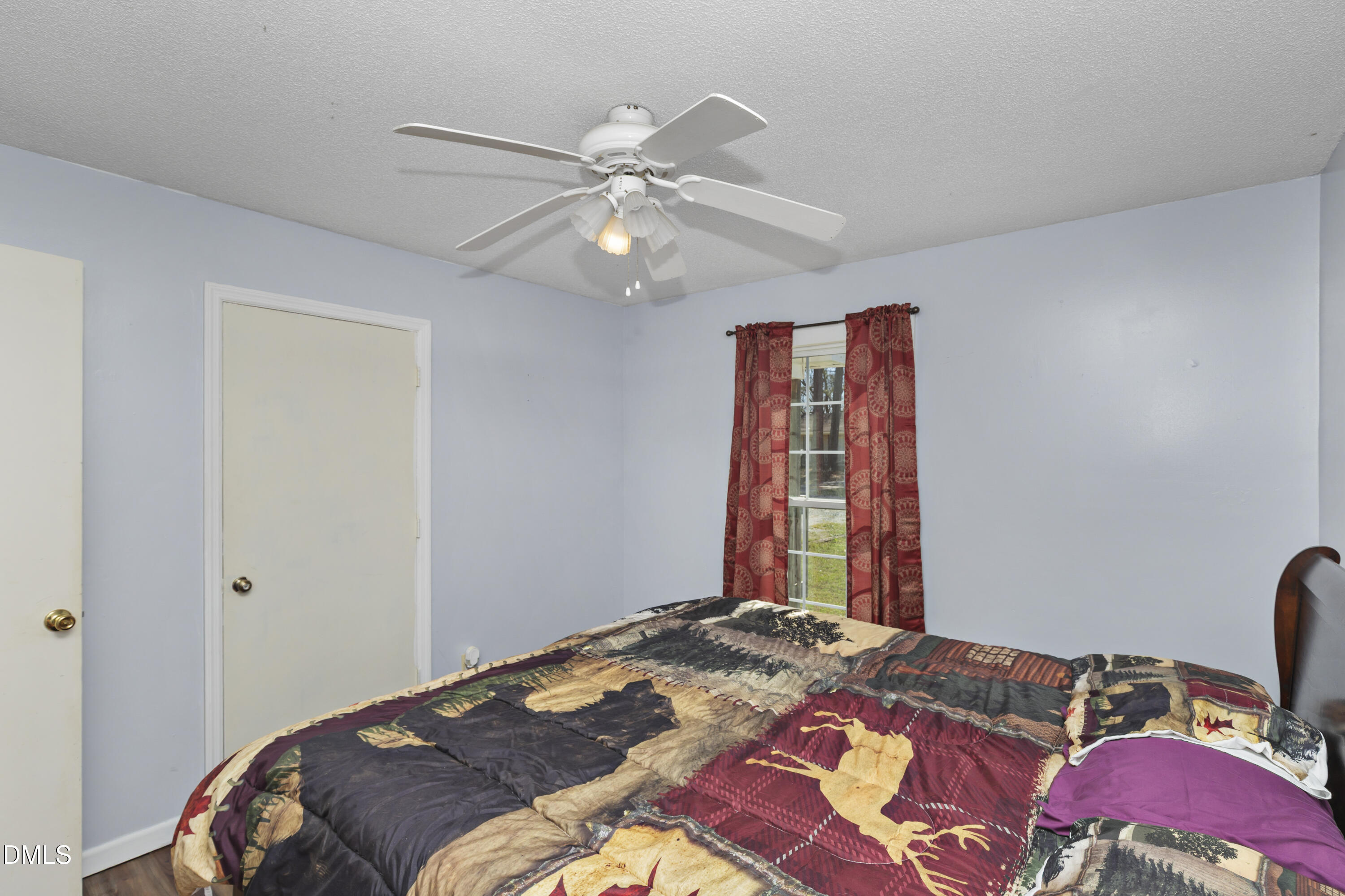 288 Baileys Crossroads Road Benson, NC 27504 - Photo 15 of 26 a bedroom with a bed and a chandelier