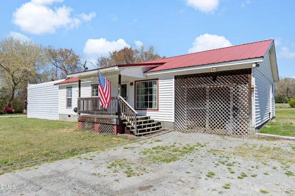 a view of a house with a yard and wooden fence
