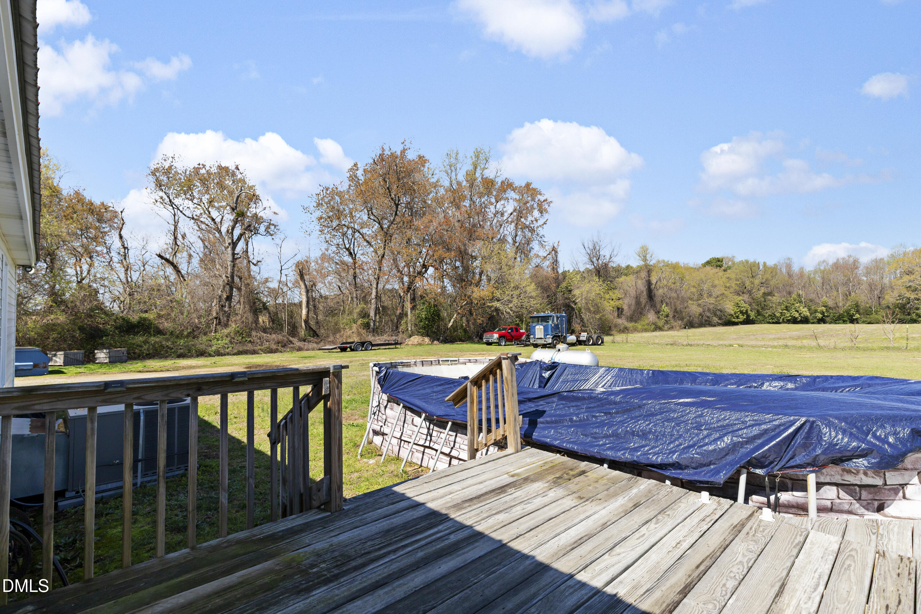 288 Baileys Crossroads Road Benson, NC 27504 - Photo 22 of 26 a view of a wooden deck and a yard