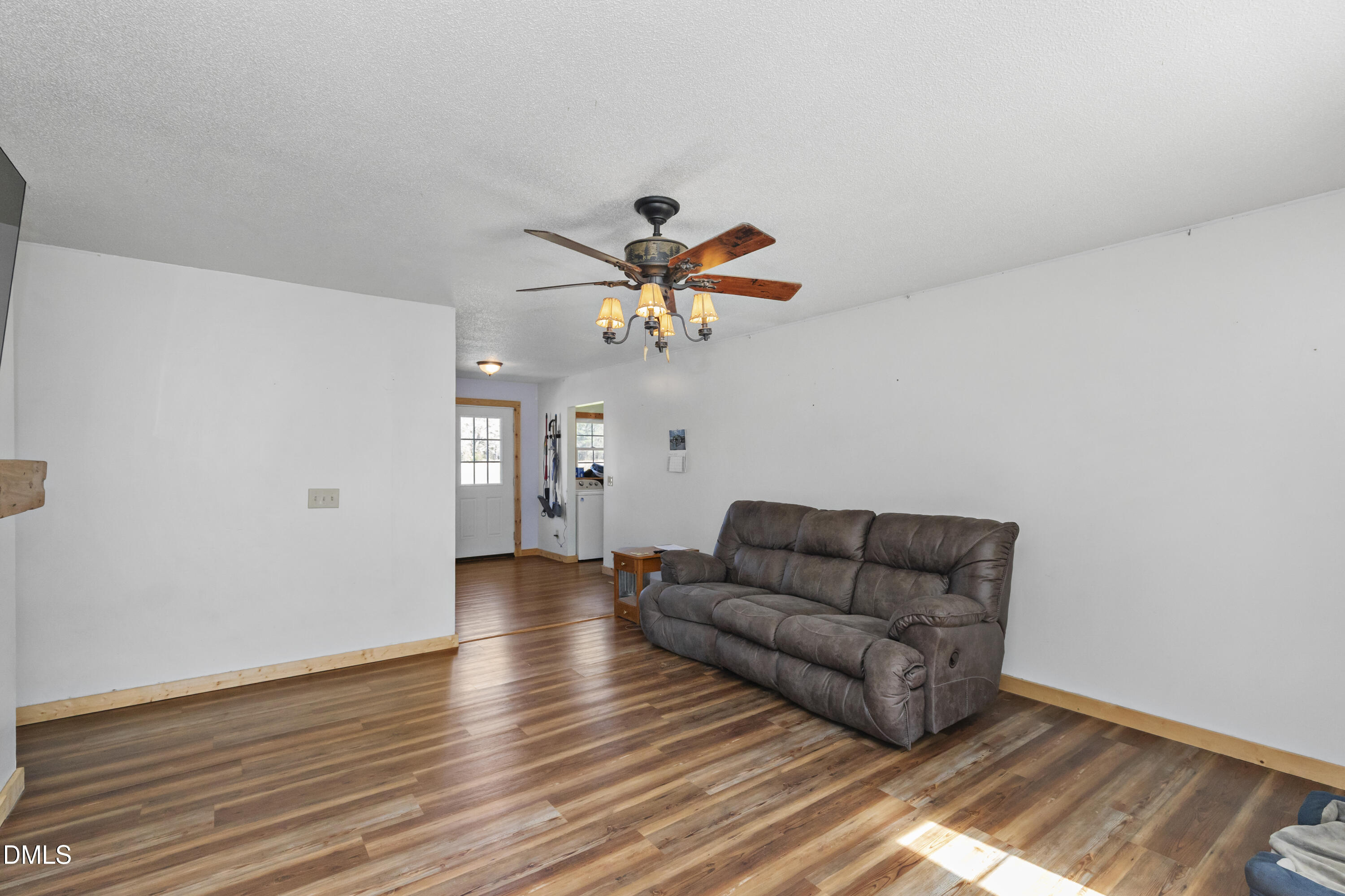 288 Baileys Crossroads Road Benson, NC 27504 - Photo 4 of 26 a living room with couches and a ceiling fan with wooden floor