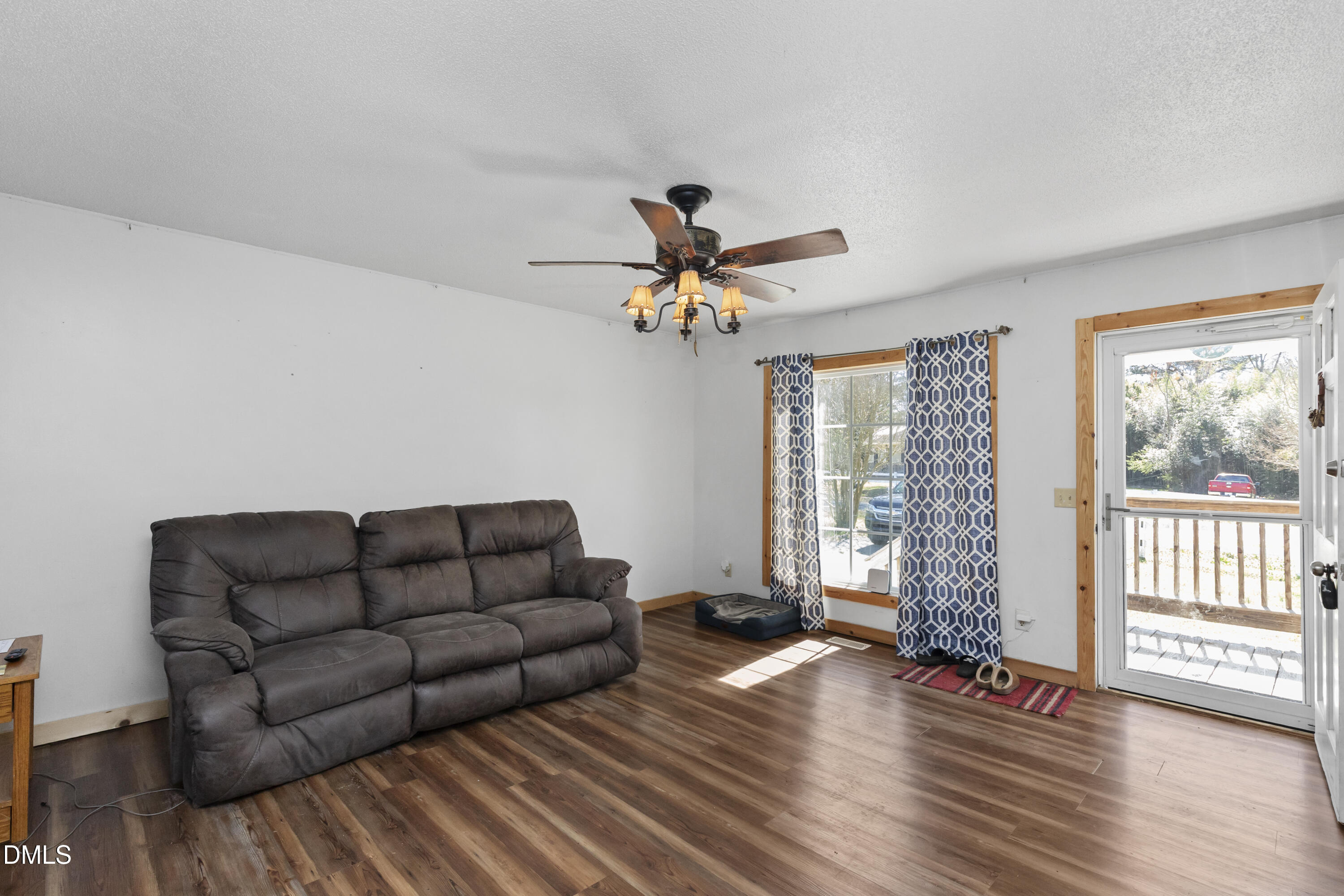 288 Baileys Crossroads Road Benson, NC 27504 - Photo 7 of 26 a living room with furniture and wooden floor