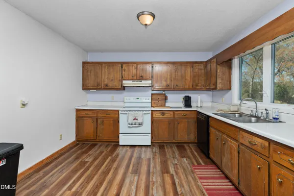 a kitchen with sink cabinets and window