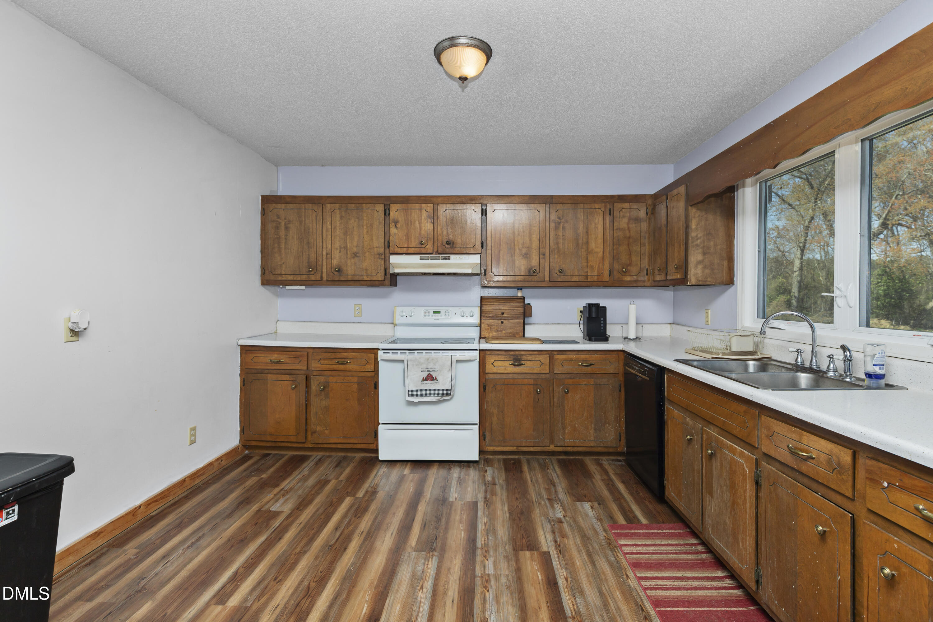 288 Baileys Crossroads Road Benson, NC 27504 - Photo 9 of 26 a kitchen with sink cabinets and window
