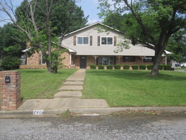 2801 Pyramid Circle Denison, TX 75020 - Photo 1 of 18 a front view of a house with a yard