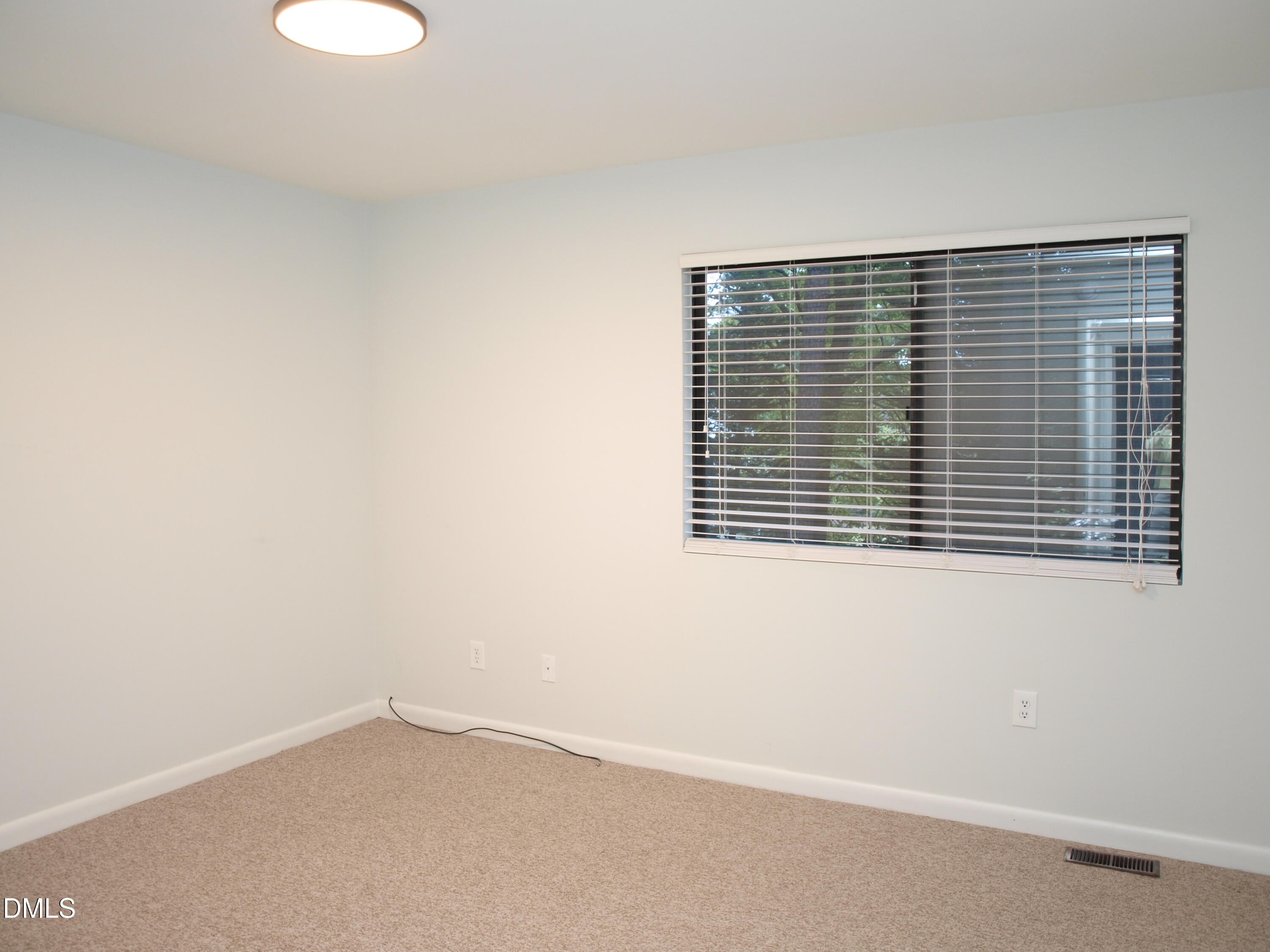 6915 Staghorn Lane Raleigh, NC 27615 - Photo 7 of 12 an empty room with a window