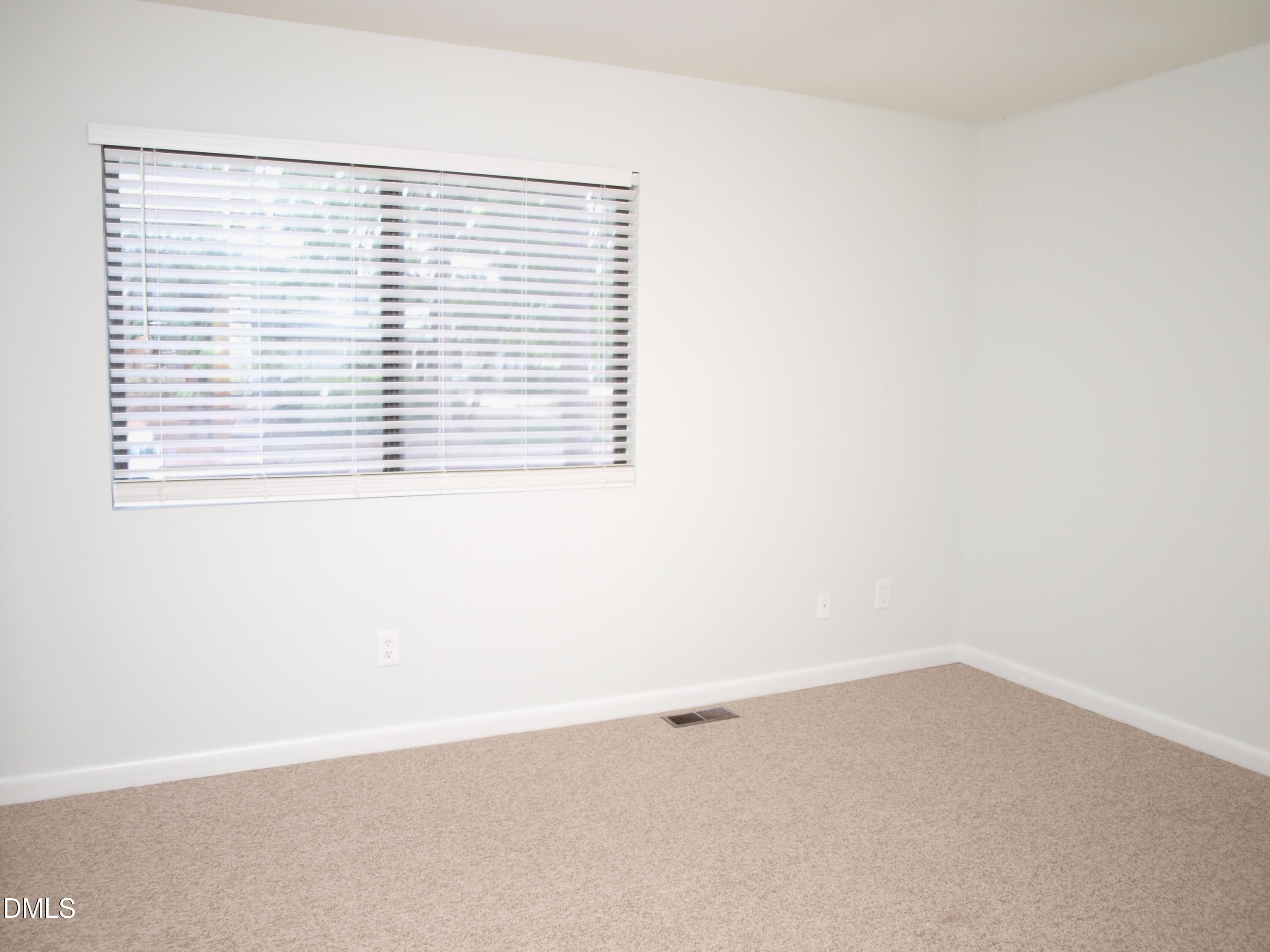 6915 Staghorn Lane Raleigh, NC 27615 - Photo 9 of 12 an empty room with a window