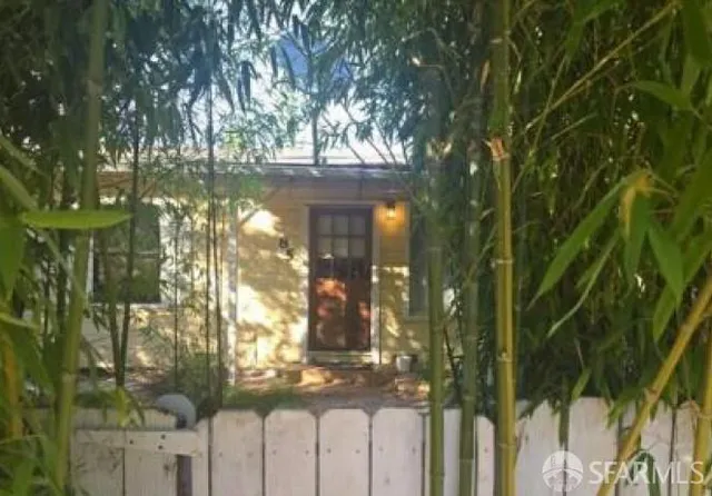 a view of a house with a tree