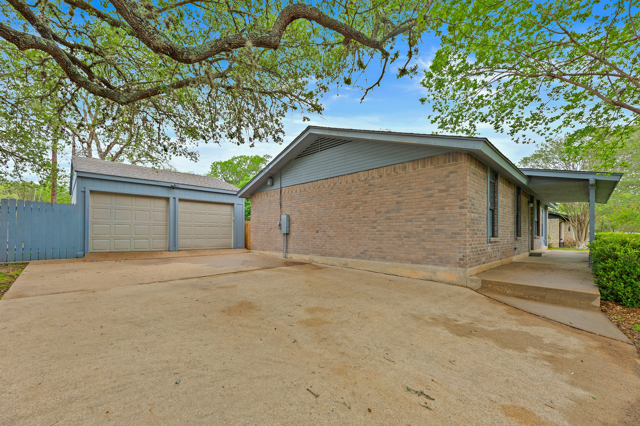 205 Hitching Post Road Kyle, TX 78640 - Photo 2 of 20 A detached 2-car garage plus an extended driveway means plenty of room for parking.
