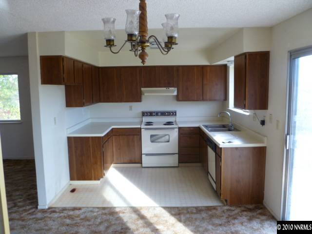 6720 Peppermint Drive Reno, NV 89506 - Photo 7 of 7 a kitchen with a stove a sink and a refrigerator