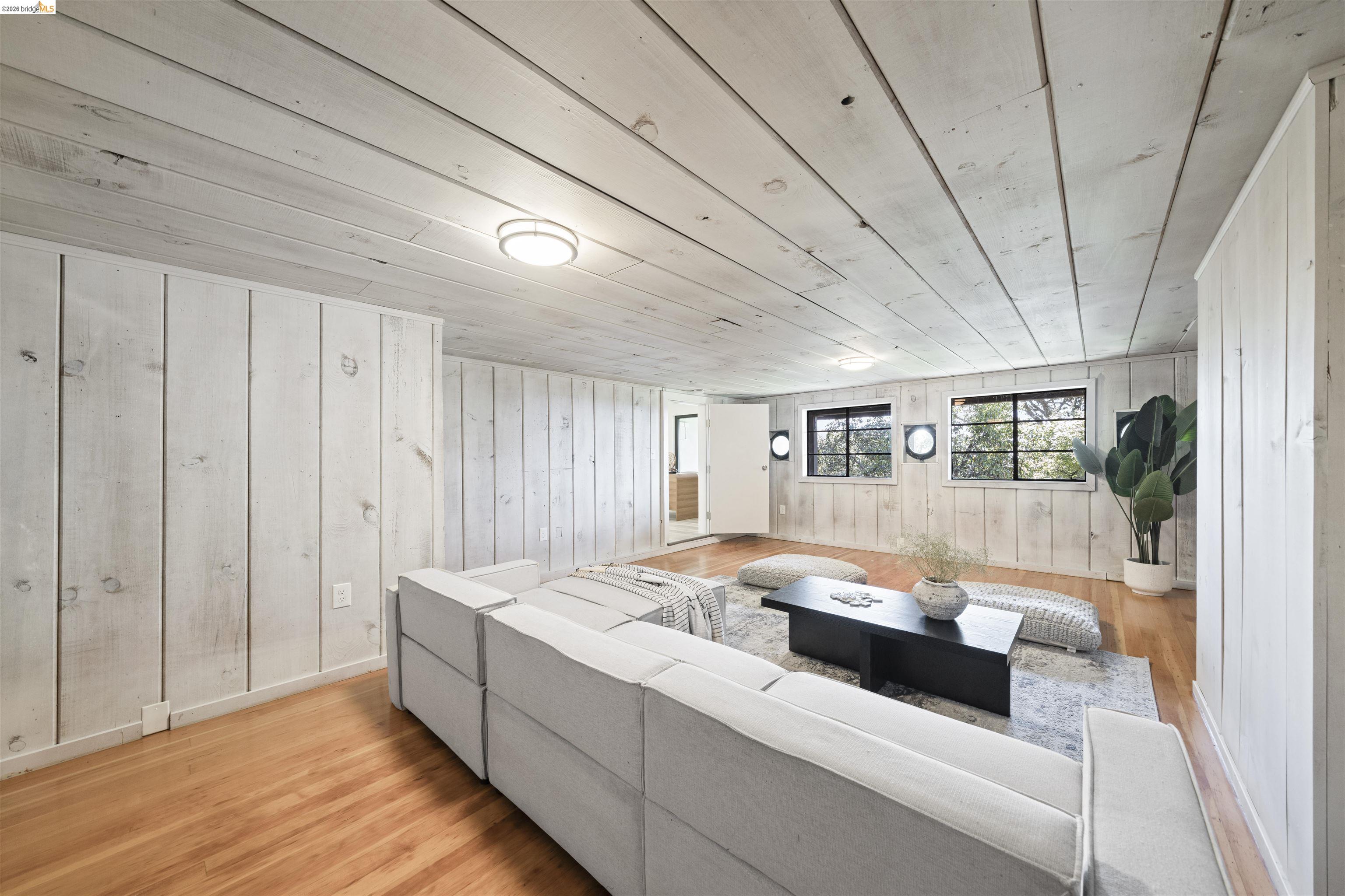 1170 Sterling Avenue Berkeley, CA 94708 - Photo 43 of 52 Living room featuring light wood-style flooring, wood ceiling, and wood walls