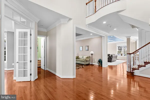 a kitchen with stainless steel appliances granite countertop a kitchen island hardwood floor and a sink