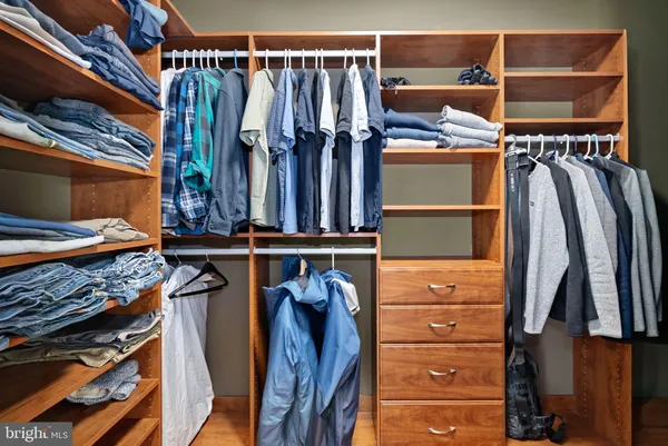 a living room with furniture a flat screen tv and gym equipment