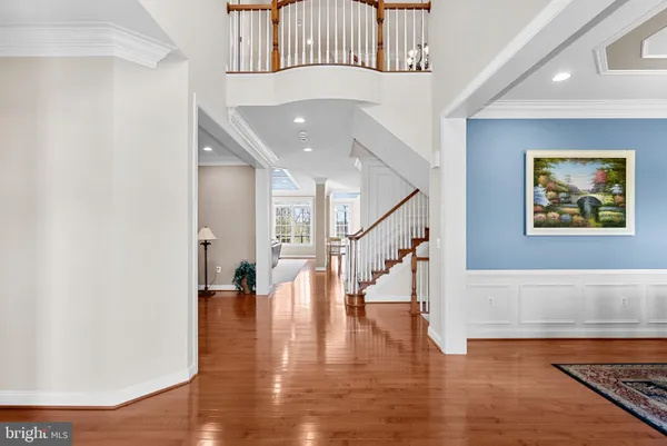 a view of an entryway with wooden floor and a rug