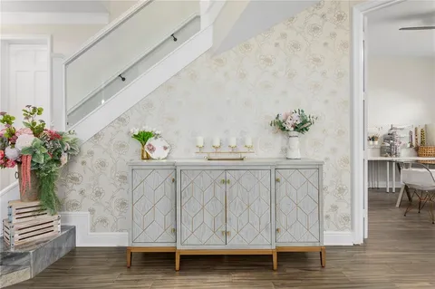 a white table with a potted plant on wooden floor
