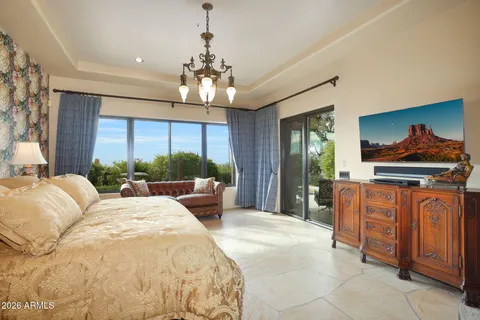 a spacious bedroom with a bed and a dresser