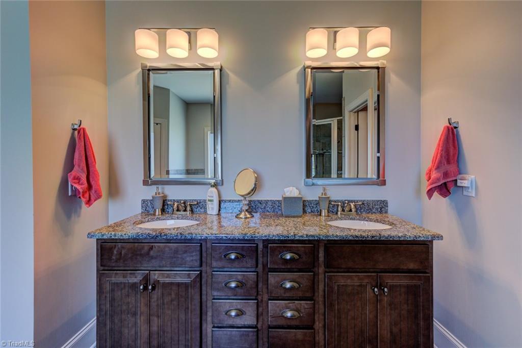 8889 Rymack Drive Oak Ridge, NC 27310 - Photo 17 of 30 Dual vanities with granite counters in master bathroom