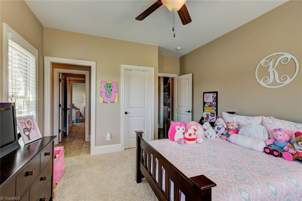 8889 Rymack Drive Oak Ridge, NC 27310 - Photo 18 of 30 Main level bedroom with walk in closet and access to Jack and Jill bathroom